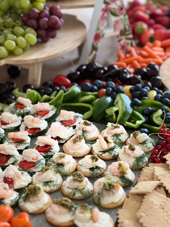 Colorful assortment of fruits, vegetables, and appetizers at a buffet.